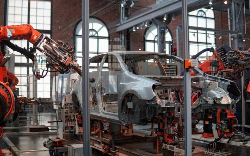 Robots are part of automotive production in an automated manufacturing plant.