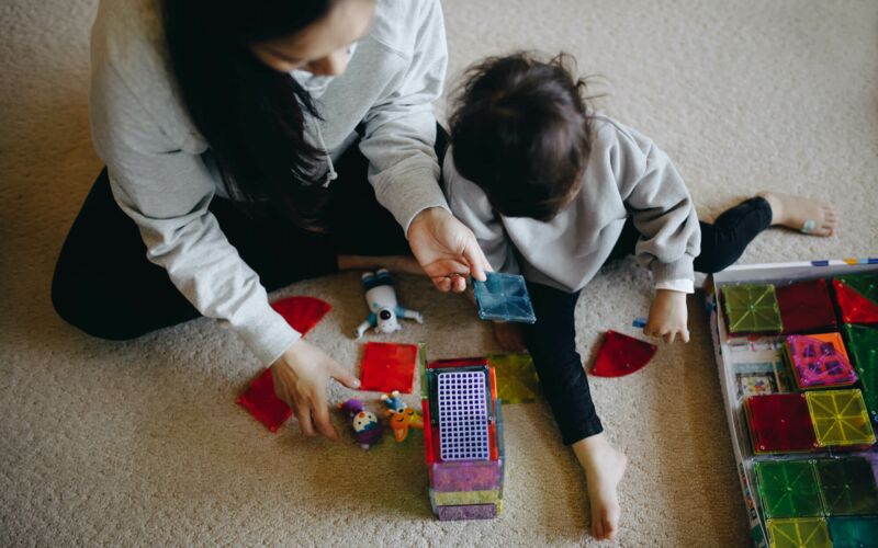 Woman and child playing with building blocks