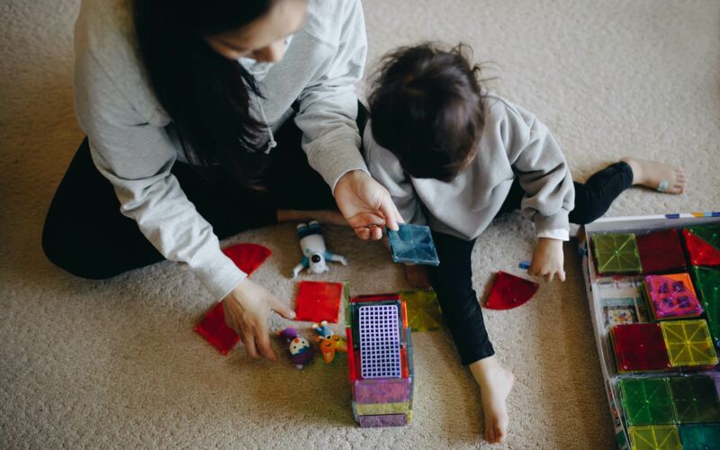 Woman and child playing with building blocks