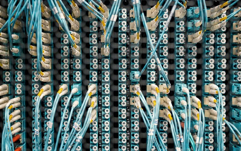 White and blue cables at the back of an Internet Server Rack