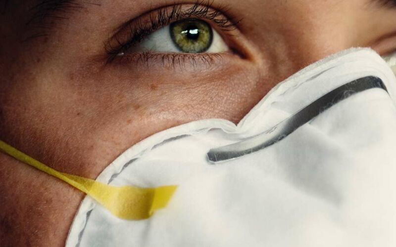 Close-up of a female portrait with respirator mask.