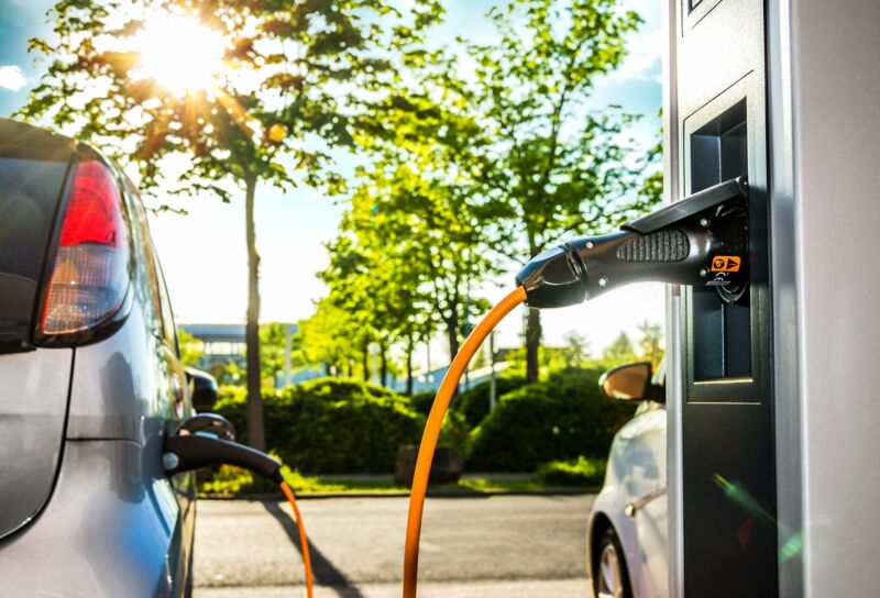 Electric car on a charging station with light candle details
