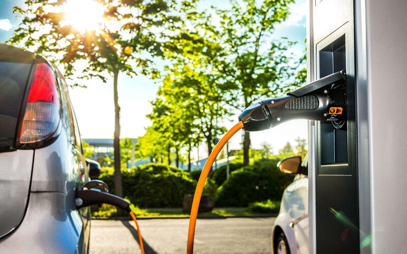 Electric car on a charging station with light candle details